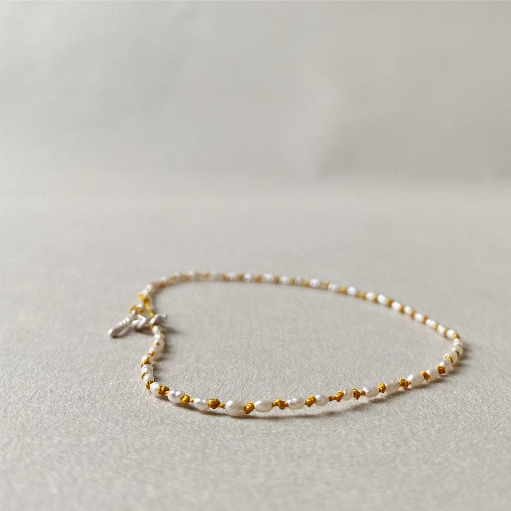 Jewel: bracelet pearls and yellow silk